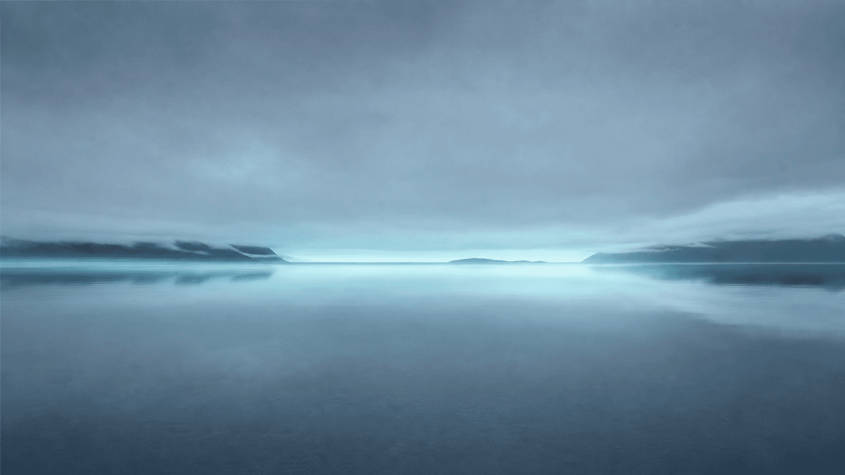 First dawn light over still water